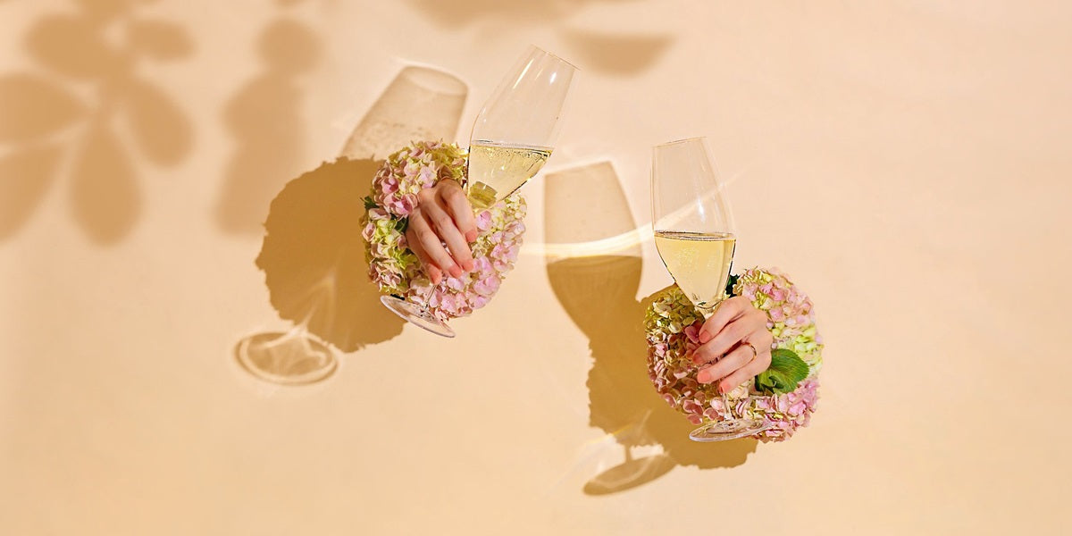 NUDE Mr&Mrs night water set in green and dusty rose, presented with the Pigmento pitcher with roes and presented on a rose table with a cheesecake in front