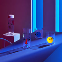 Lifestyle image of NUDE Rock & Pop glass collection with jug, highball glass and whisky glass in dark neon environment
